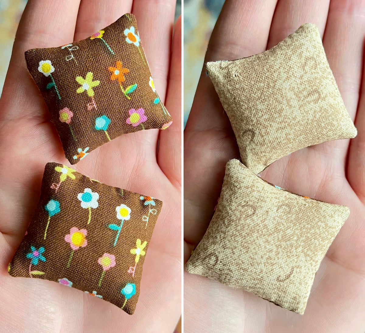 Two small fabric pillows, front with floral pattern and back plain, held in hands.