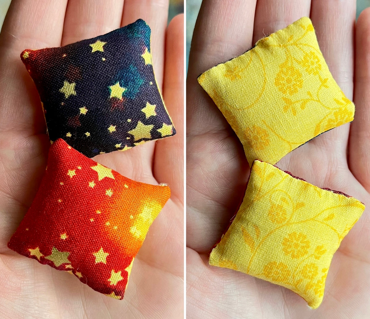Two small fabric pillows with star patterns held in hands.