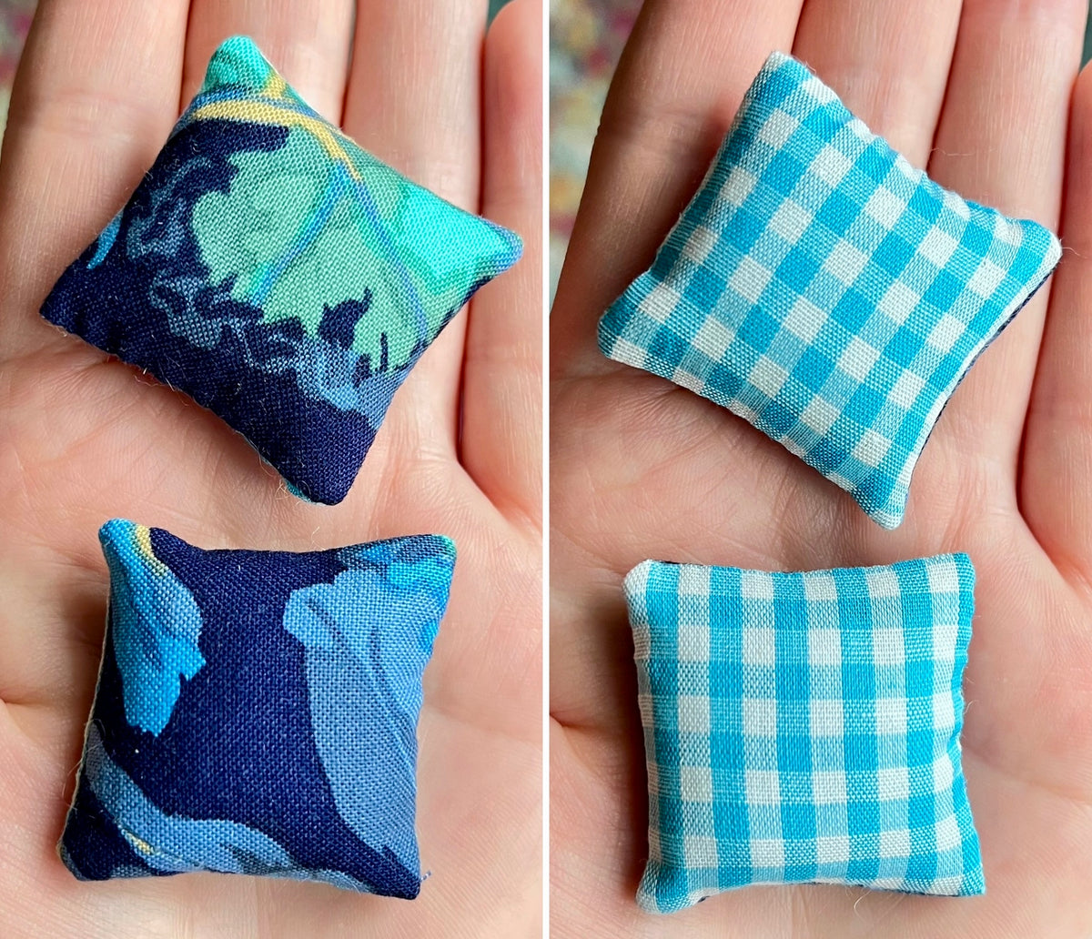 Two small fabric pillows, front blue with a pattern and back blue checkered, held in hands.