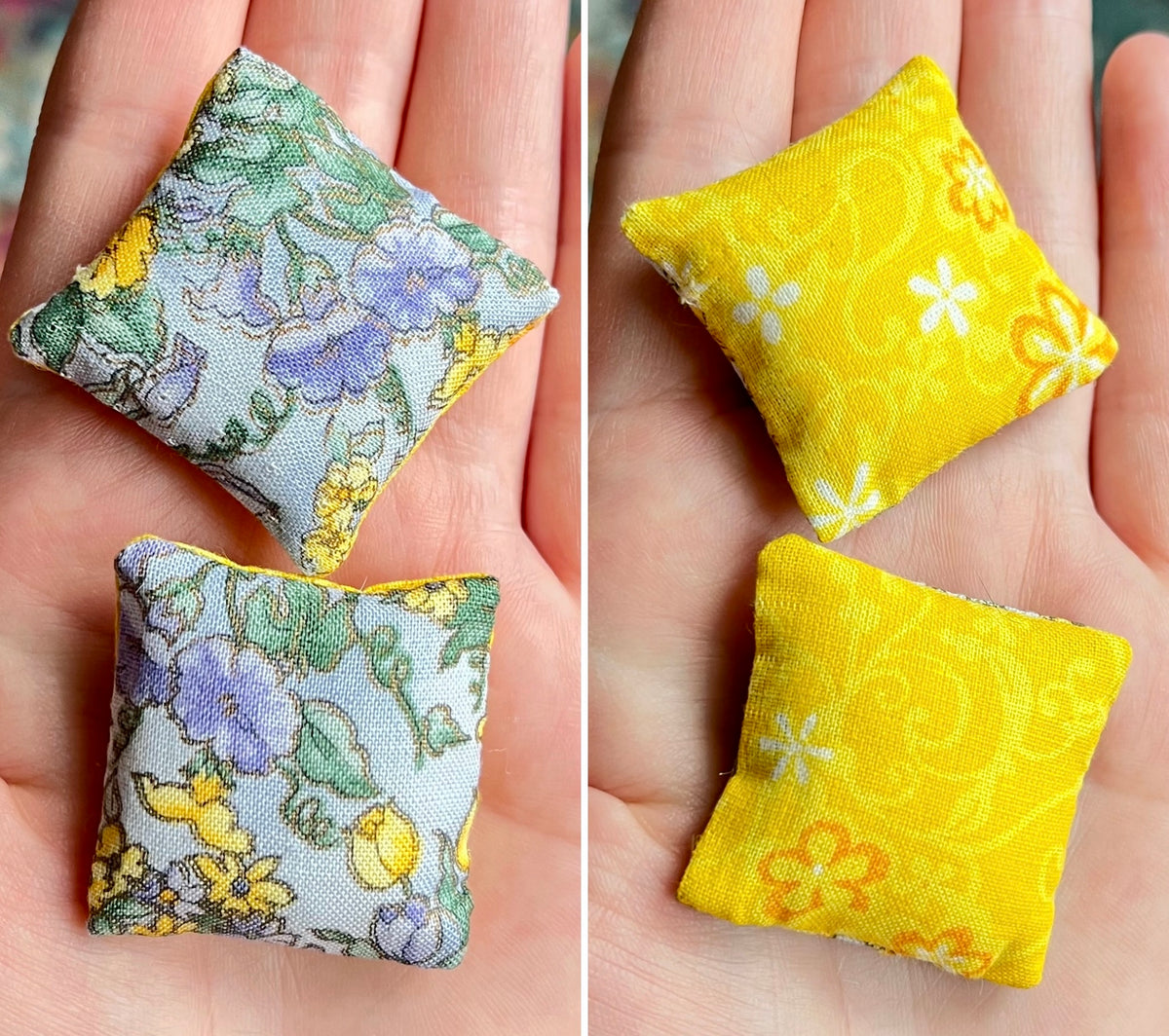 Two small fabric pillows with floral patterns held in hands.