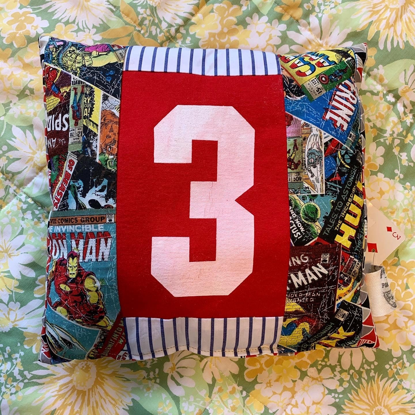 A very cute tooth fairy pillow featuring a jersey number three with superhero fabric