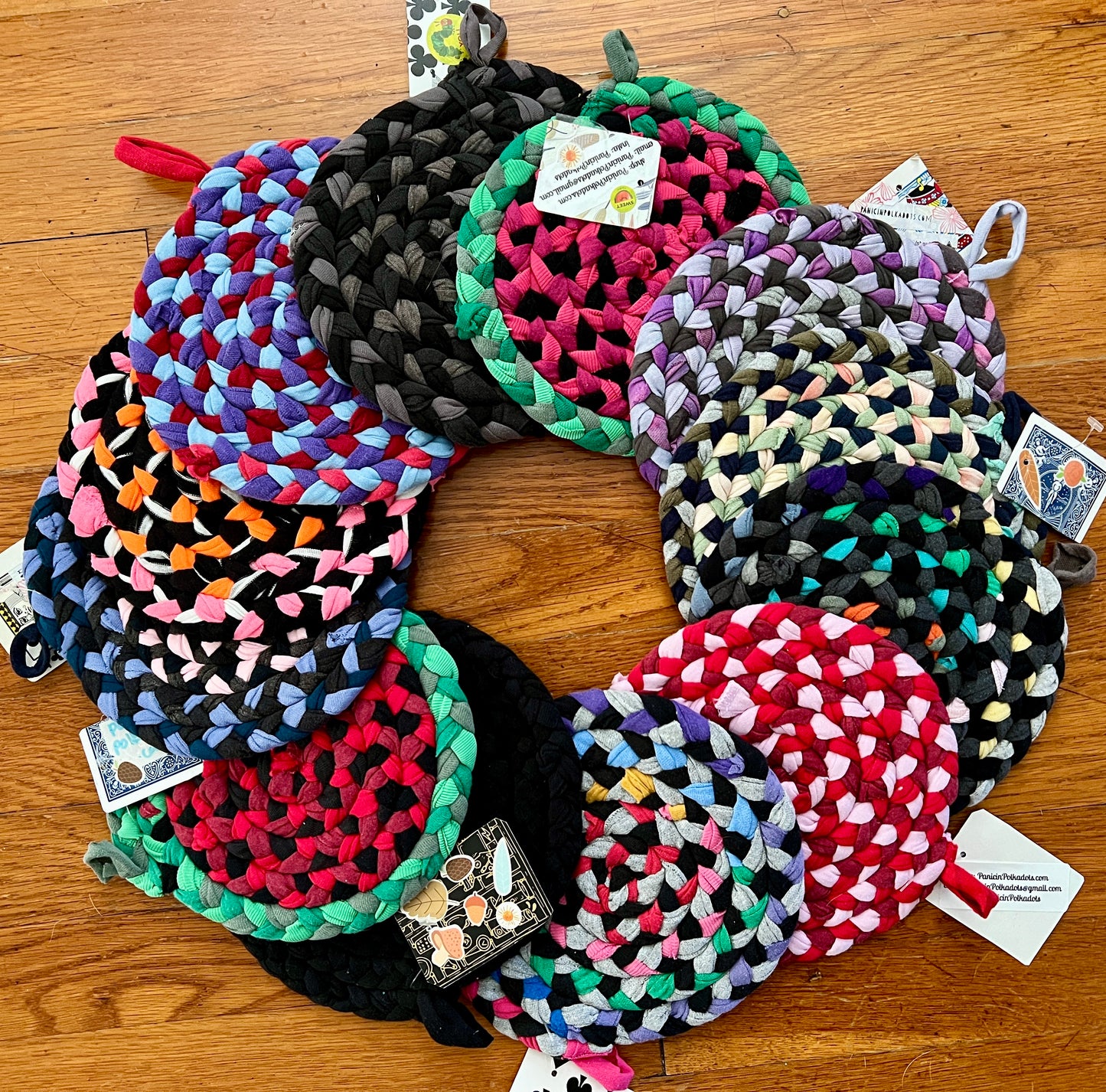 Trivet potholders group in circle array On wood background