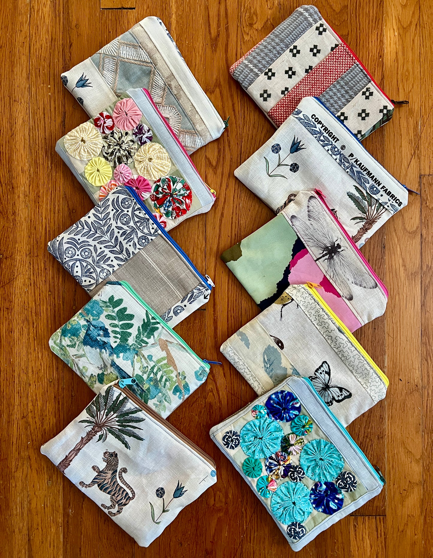 Zipper pouches designer offcuts, assortment on wood background