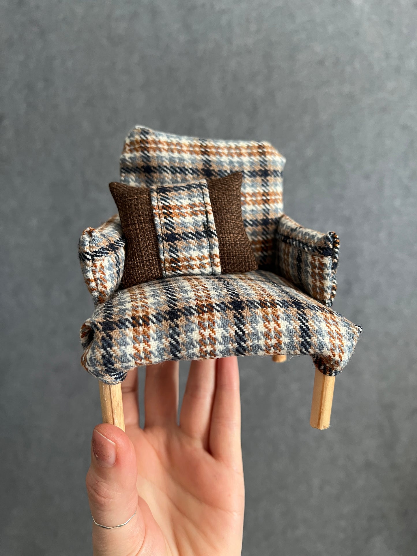 barbie chair brown plaid, held up for scale