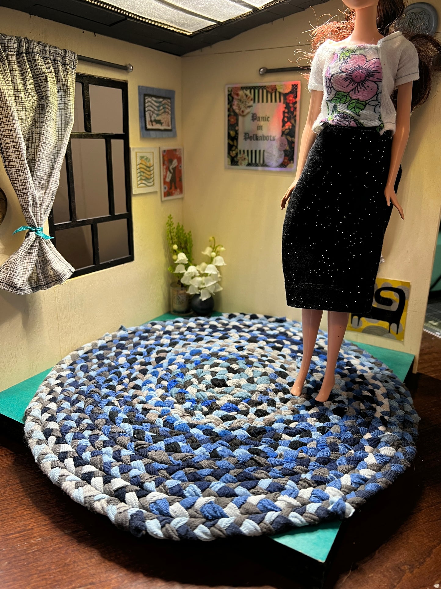 view of miniature rug in a room box, with Barbie standing atop the 11" denim blue rug for scale and display ideas