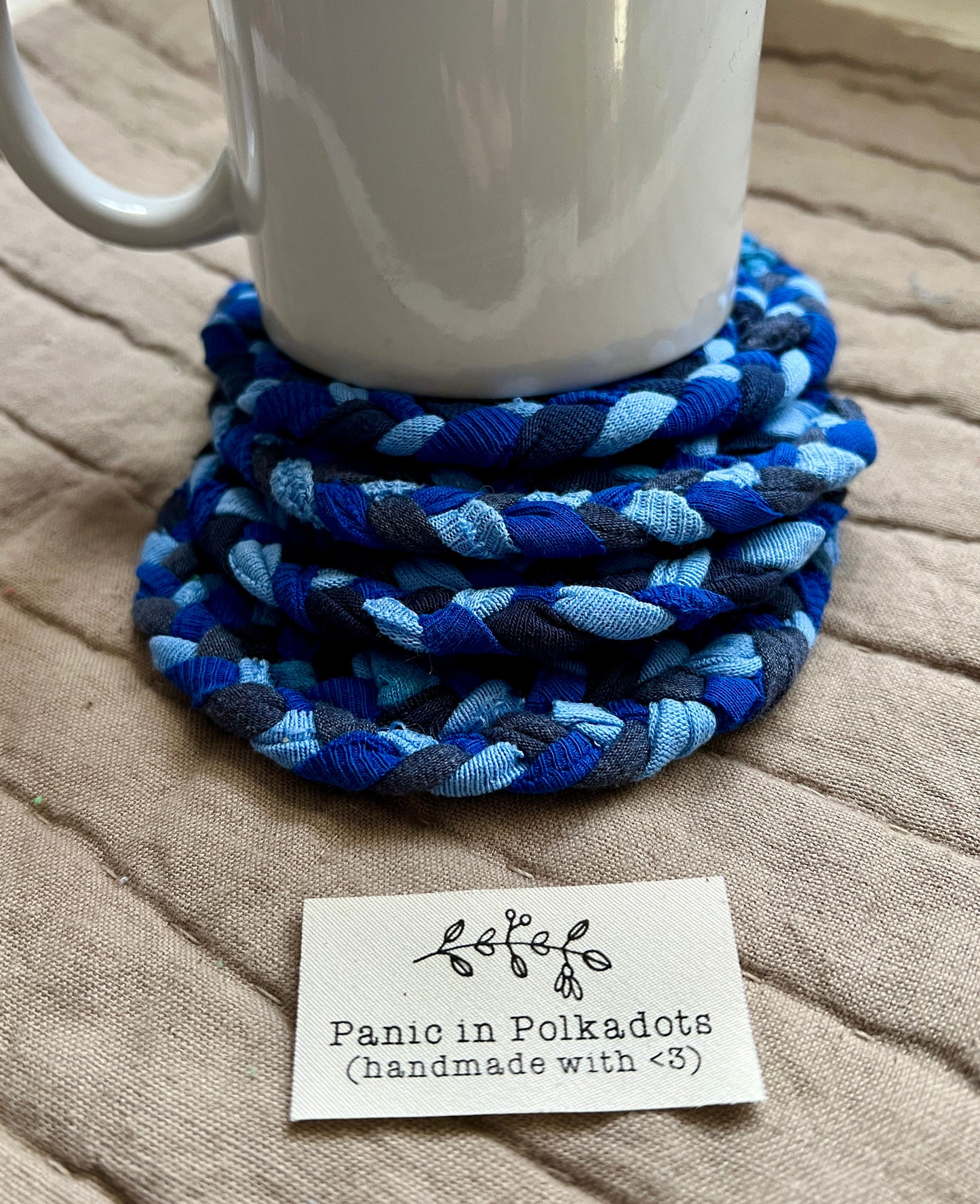 blue denim coasters under mug for scale, Panic in Polkadots label in front