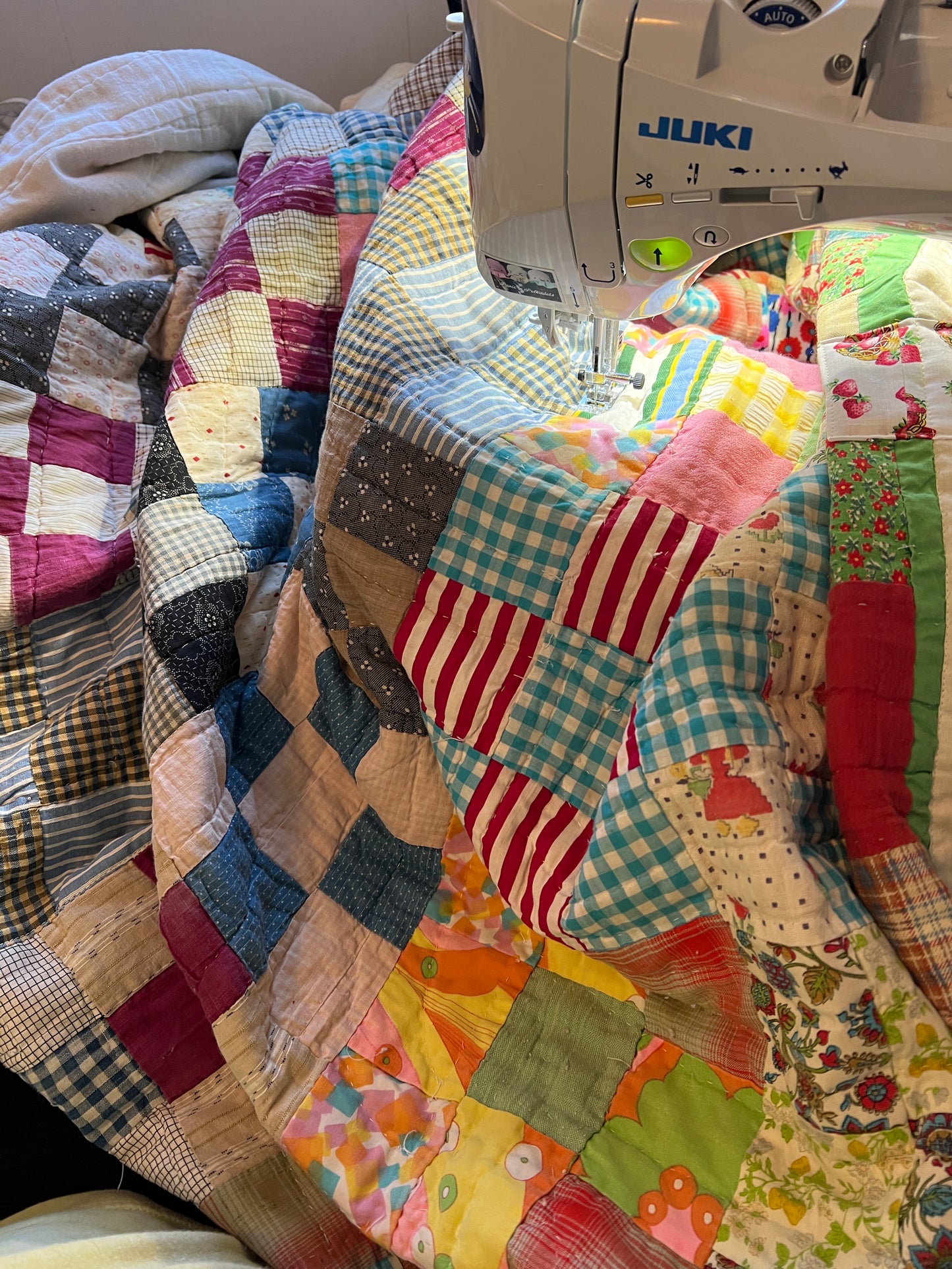 colorful nine squares quilt in progress on the sewing machine