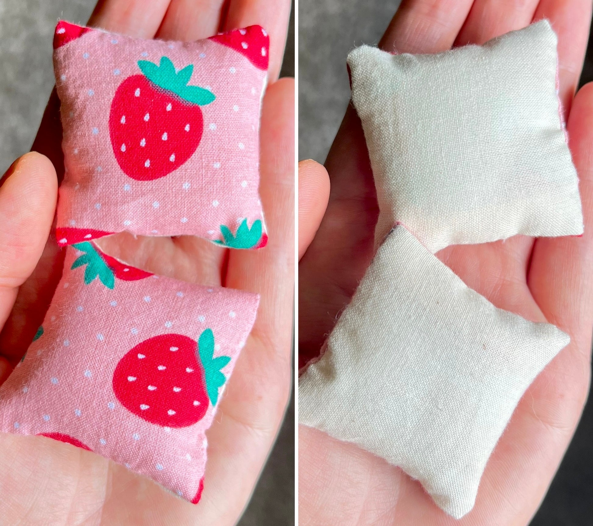 Two small fabric pillows, front with strawberry pattern and back is plain white, held in hands.