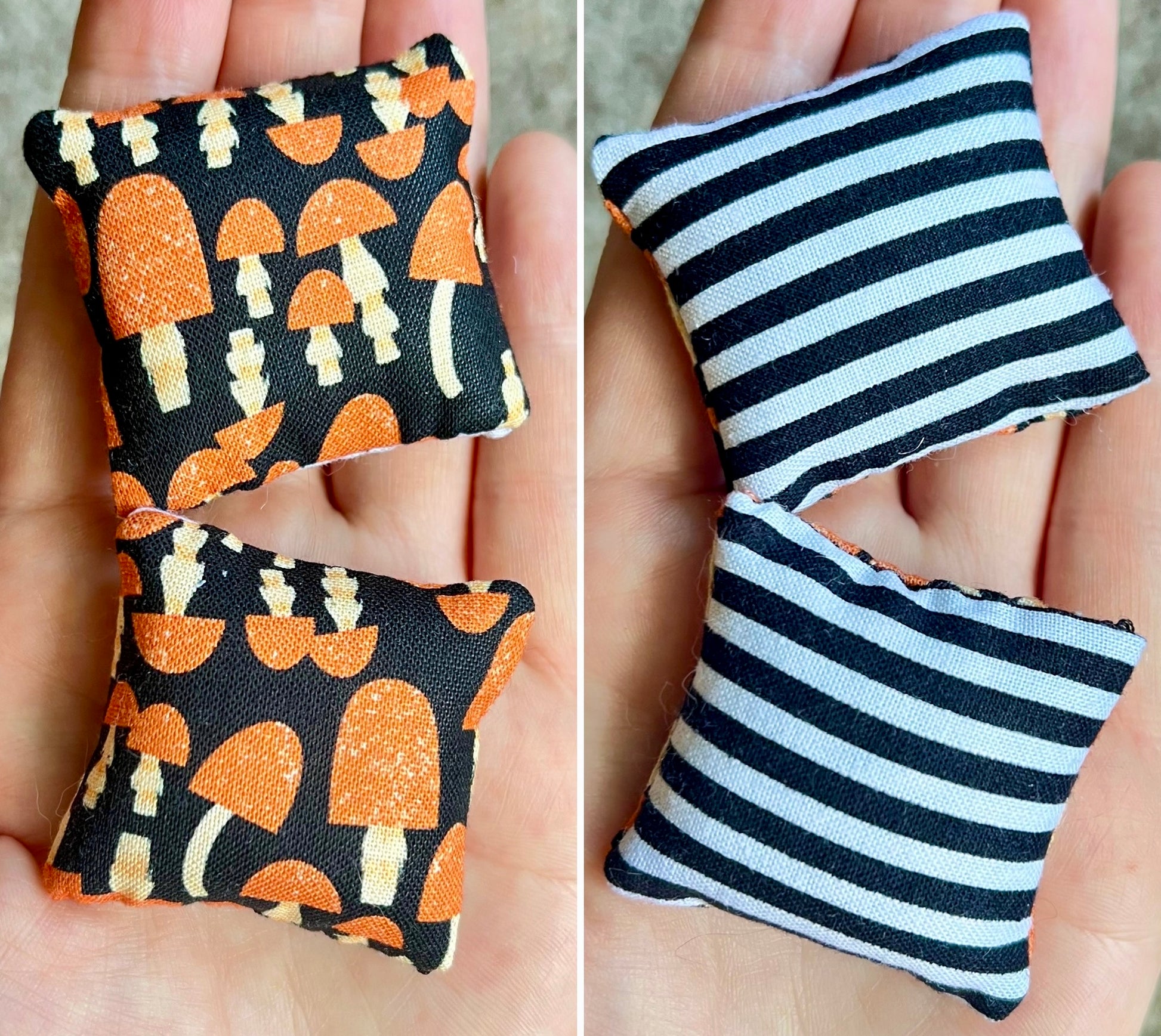 Two small fabric pillows held in hands, front with mushroom pattern and the back with black and white stripes.