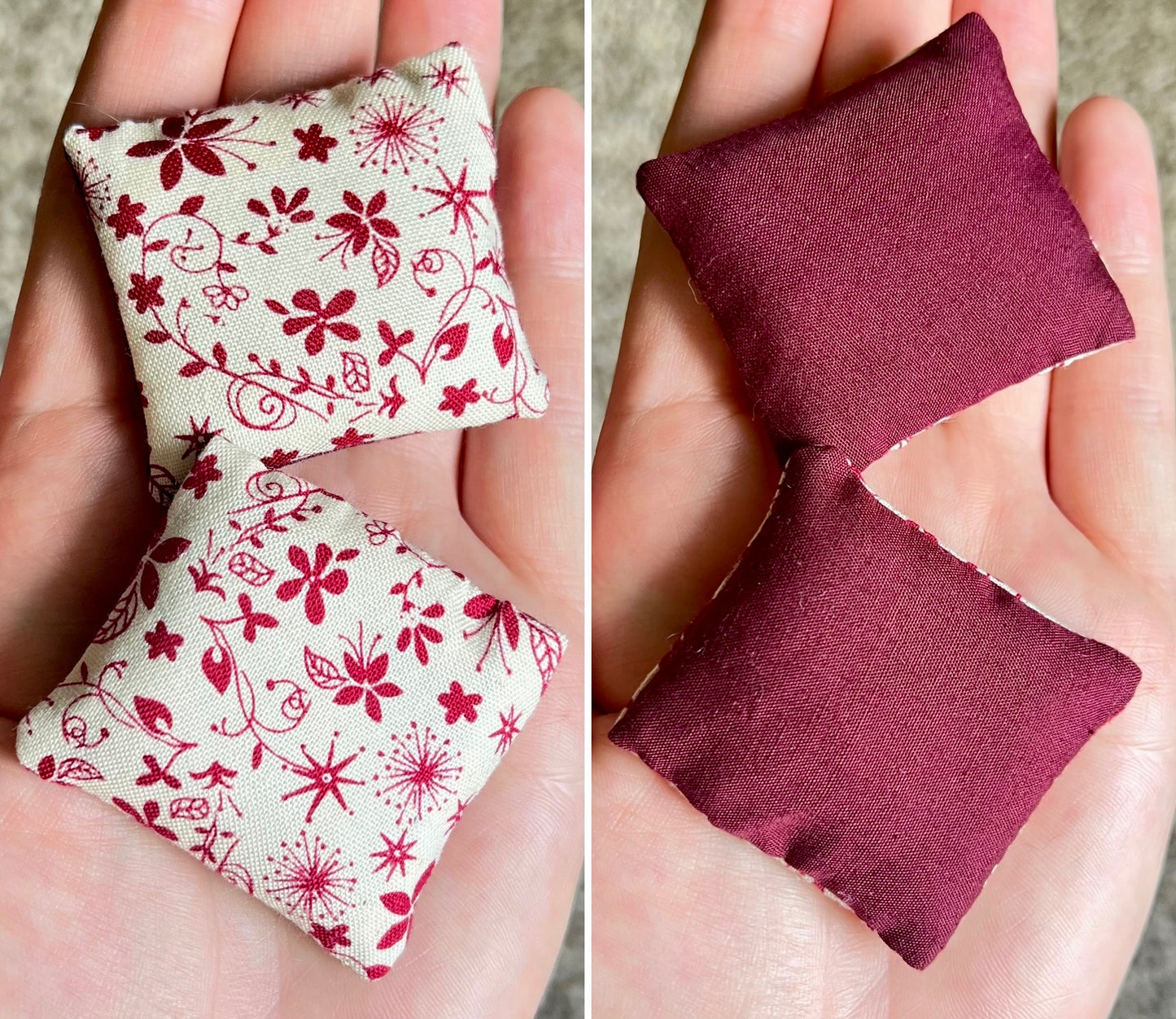 Two small fabric pillows, front with floral pattern and back is solid burgundy color, held in hands.