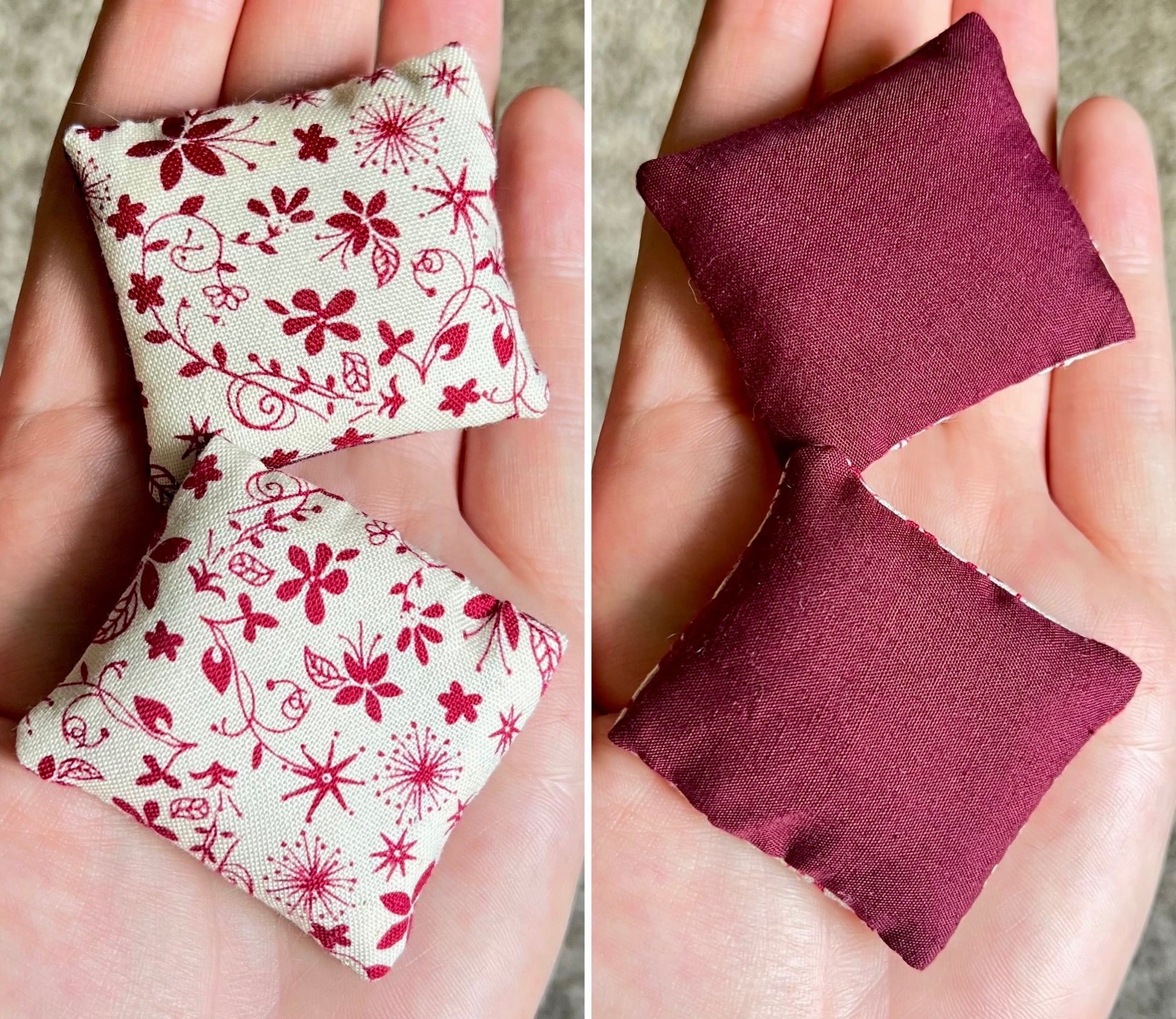 Two small fabric pillows, front with floral pattern and back is solid burgundy color, held in hands.