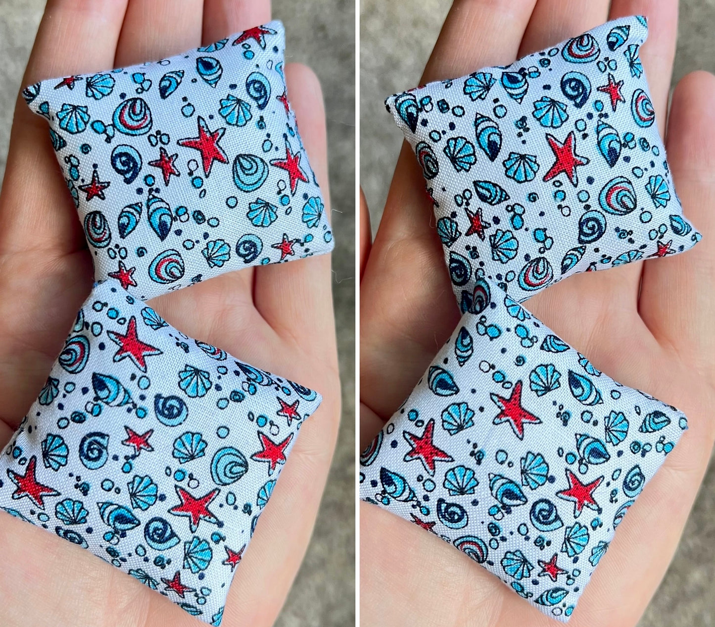 Two small fabric pillows with starfish and shell pattern held in hands.