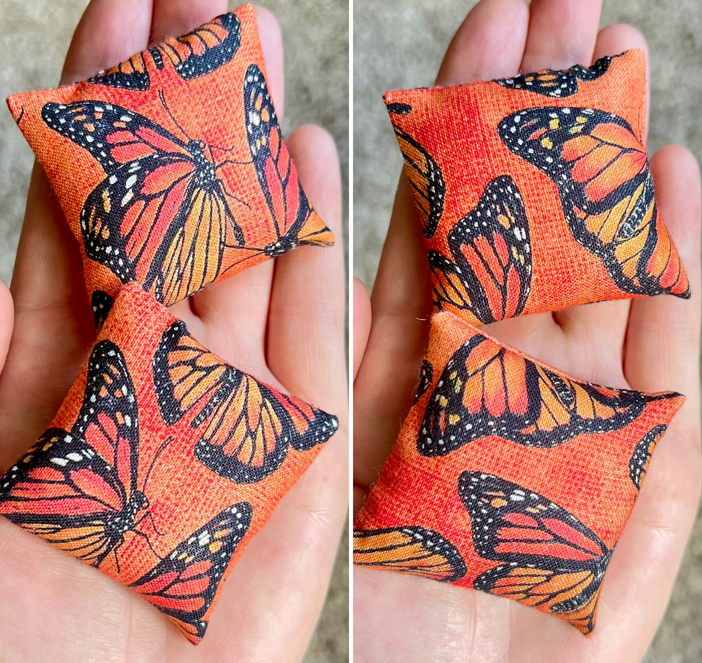Two small fabric pillows with monarch butterfly patterns held in hands.