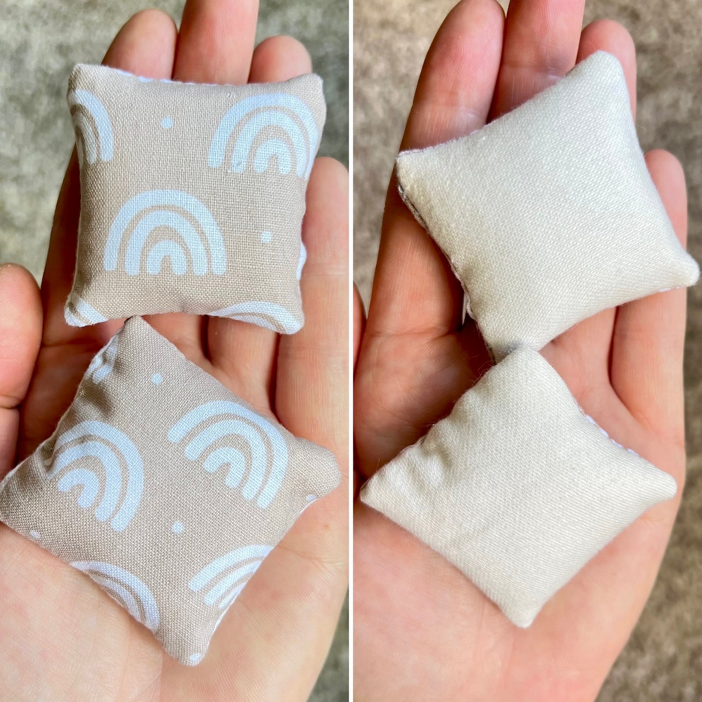 Two small fabric  doll pillows, front with neutral rainbow patterns and back is plain white, held in hands against a neutral background.