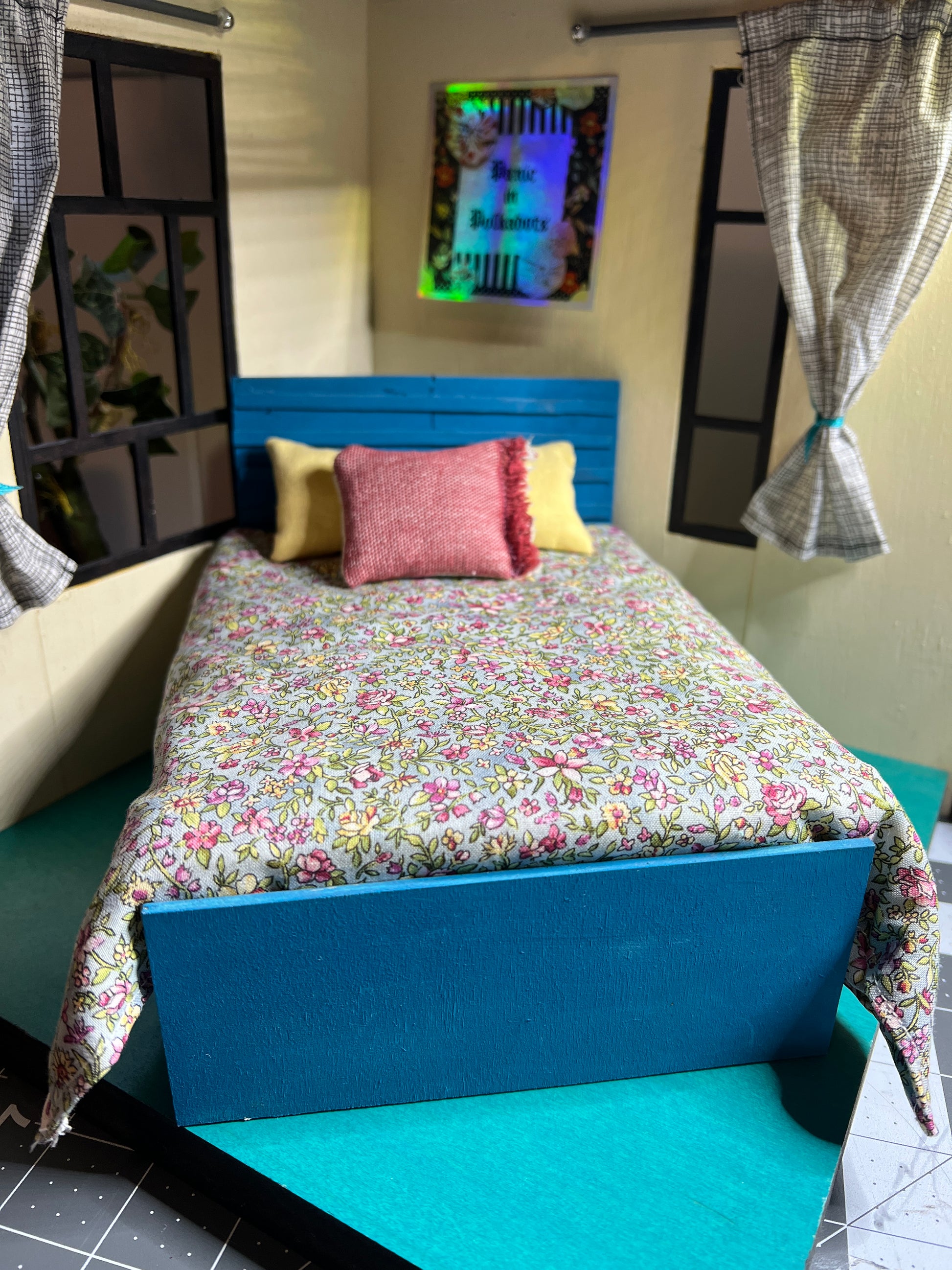 a miniature dollhouse bed, 1:12 scale, shown with comforter and pillows