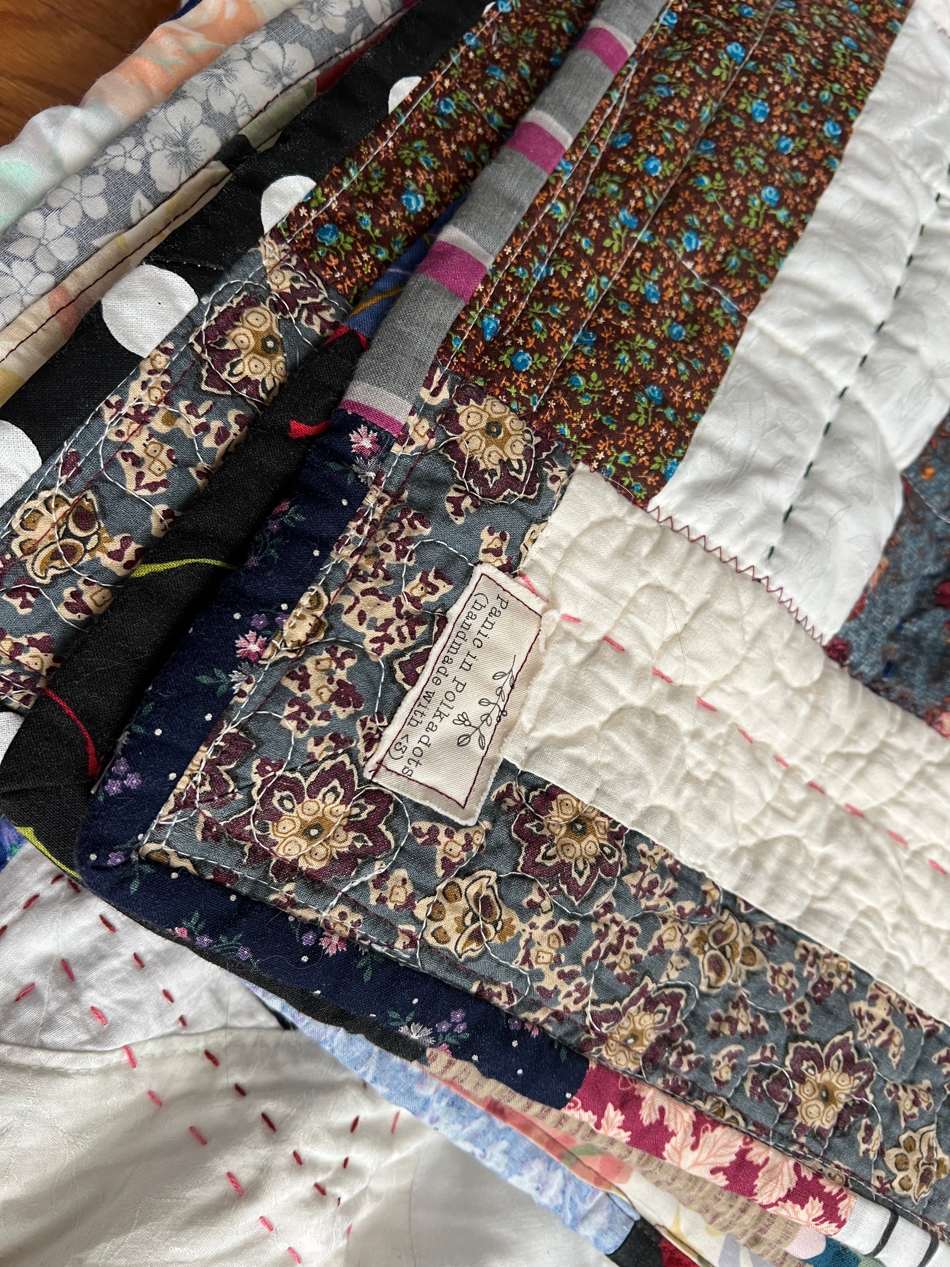 eight point stars and quilted hexies quilt, closeup on panic label