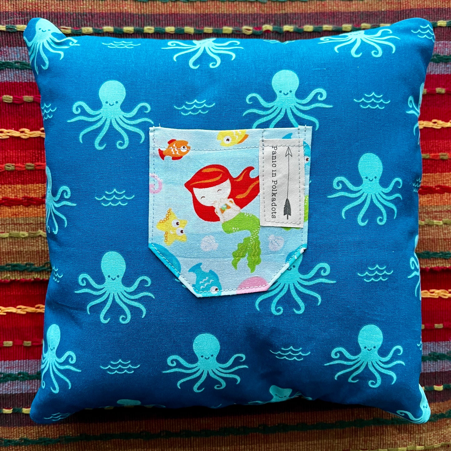 back view of flounder cathedral square pillow, with octopus print and mermaid pocket