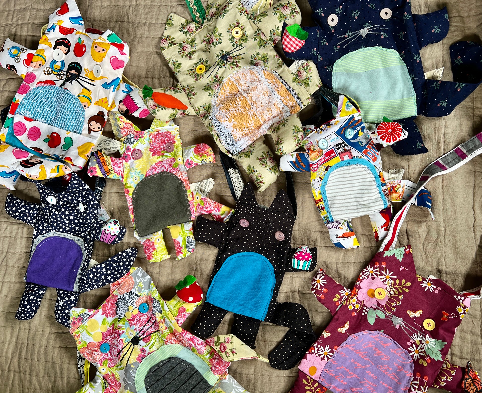 various kitty tote bags, in two different sizes, flatlay array on a neutral quilt