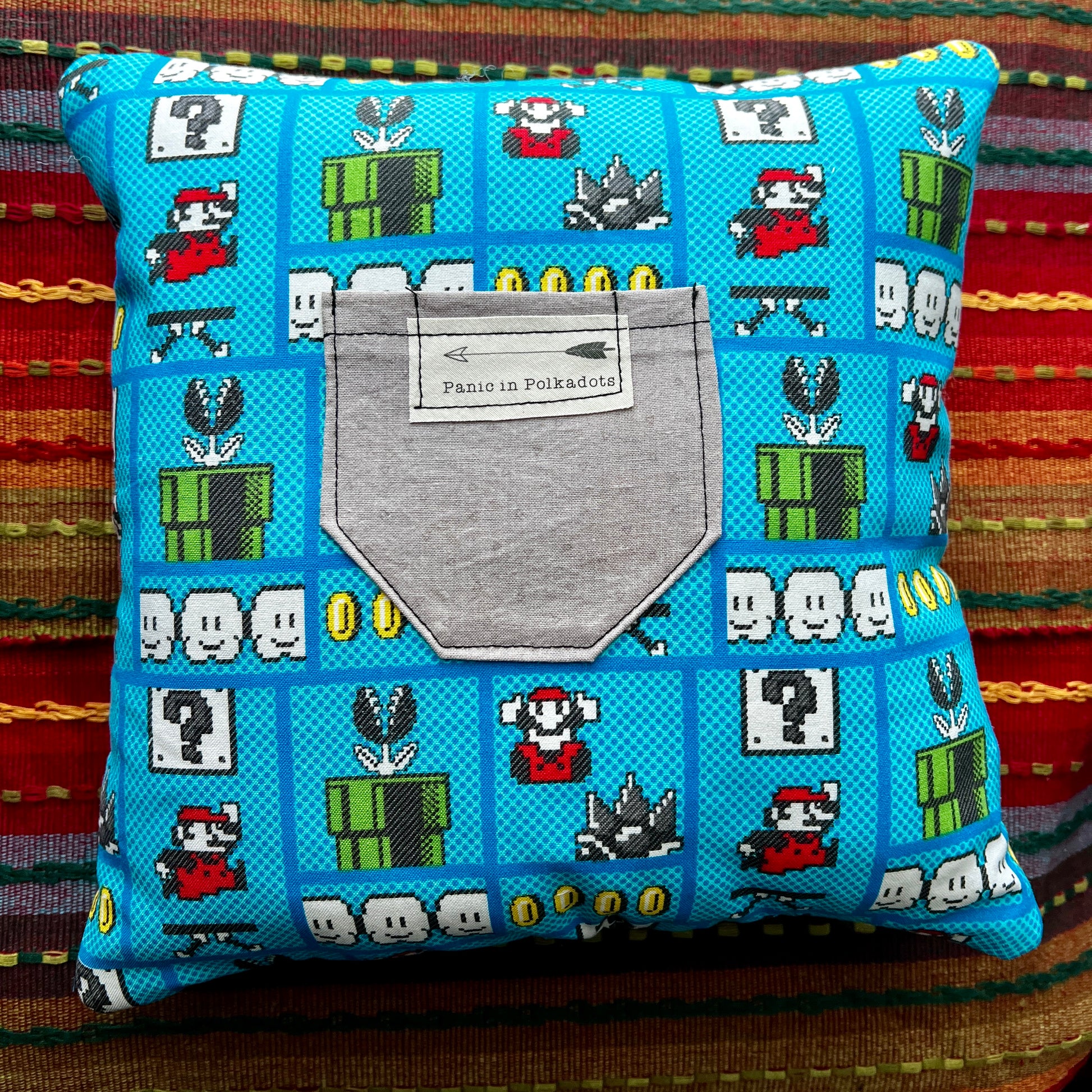 back view of mario bros cathedral square pillow, with pixel art from the og video game