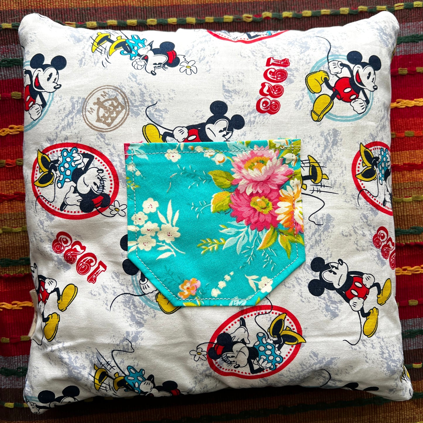 back view of mickey minnie 2 cathedral square pillow, with teal floral pocket