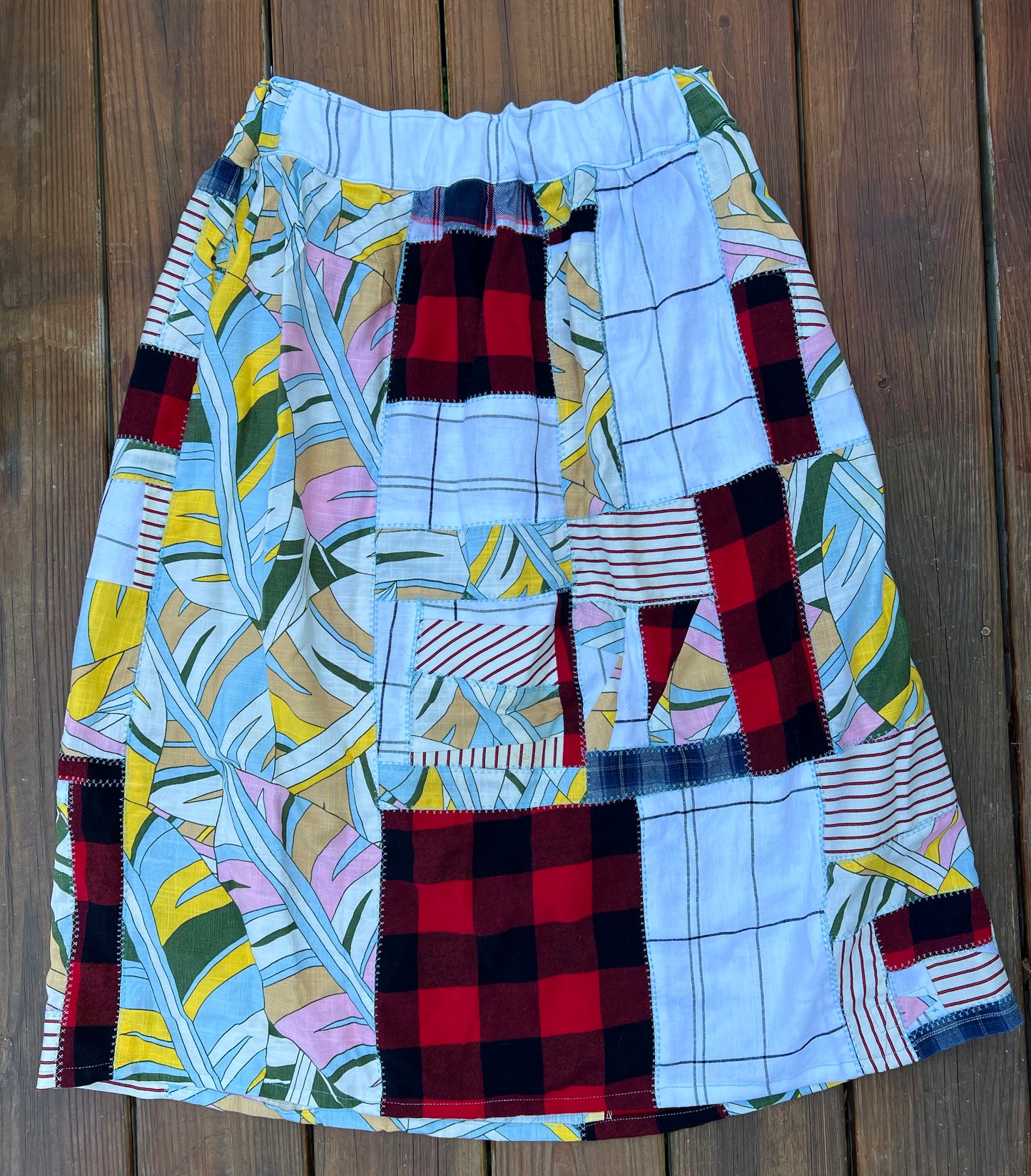 patchwork skirt flatlay, plaids, tropical leaves, upcycled, sustainable clothing
