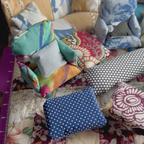 Various miniature couches, chairs, and ottoomans