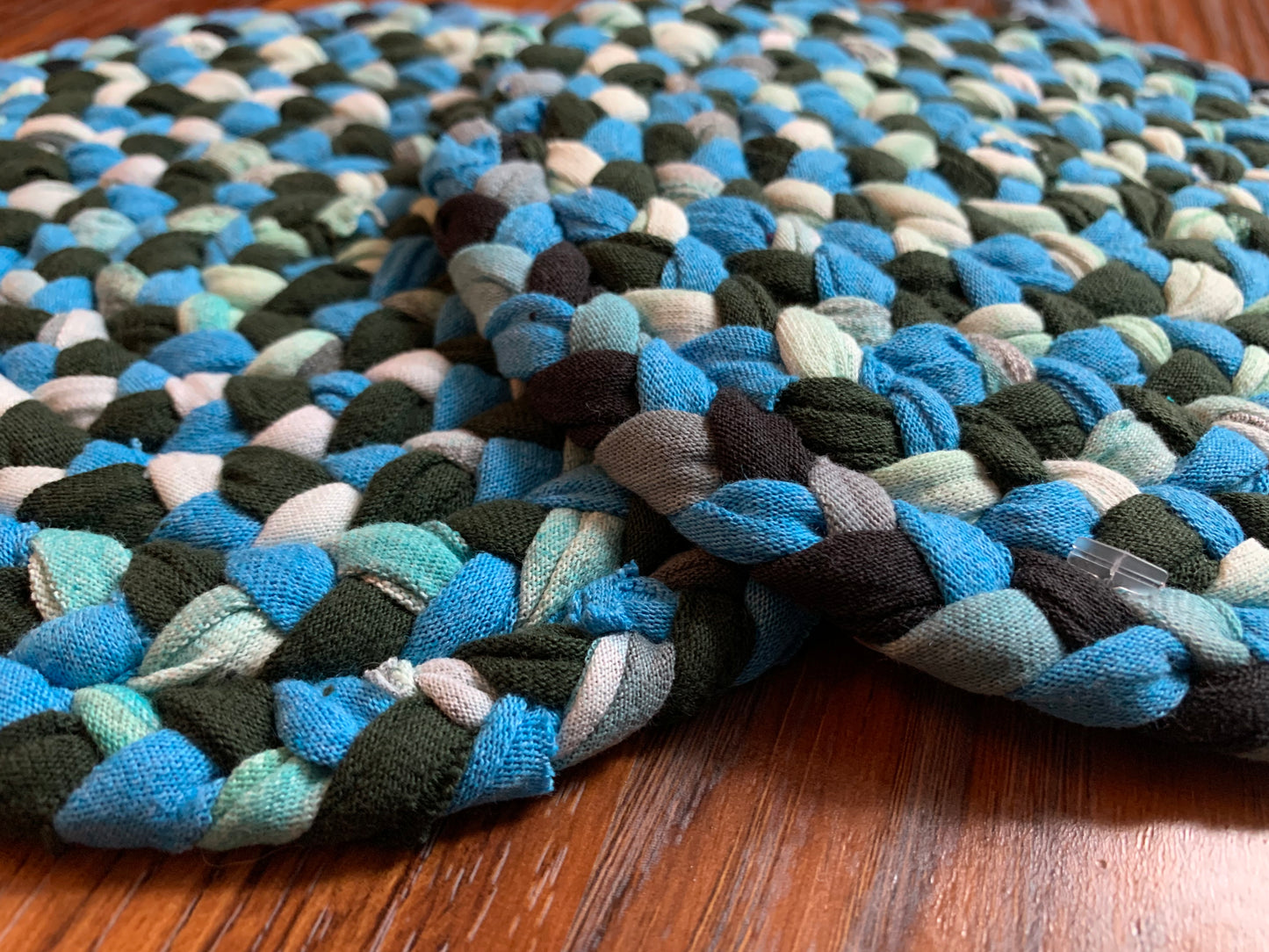 side view of a pair of trivets against a wood background